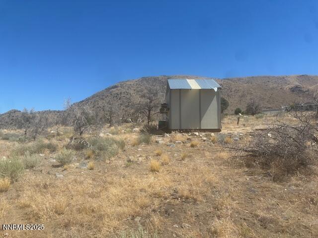 0 Pinon Place Coleville, CA 96107 - Photo 24 of 27 a view of a dry yard with trees in the background