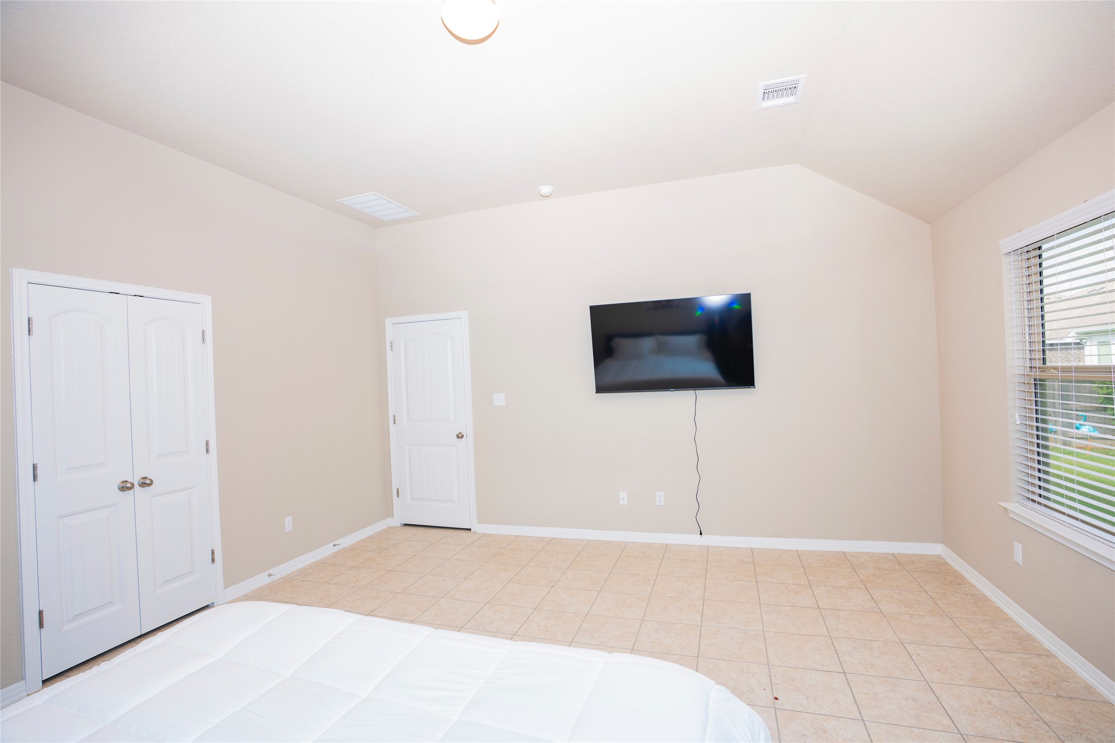 20916 Carries Ranch Road Pflugerville, TX 78660 - Photo 22 of 40 a bedroom with a bed and a flat screen tv