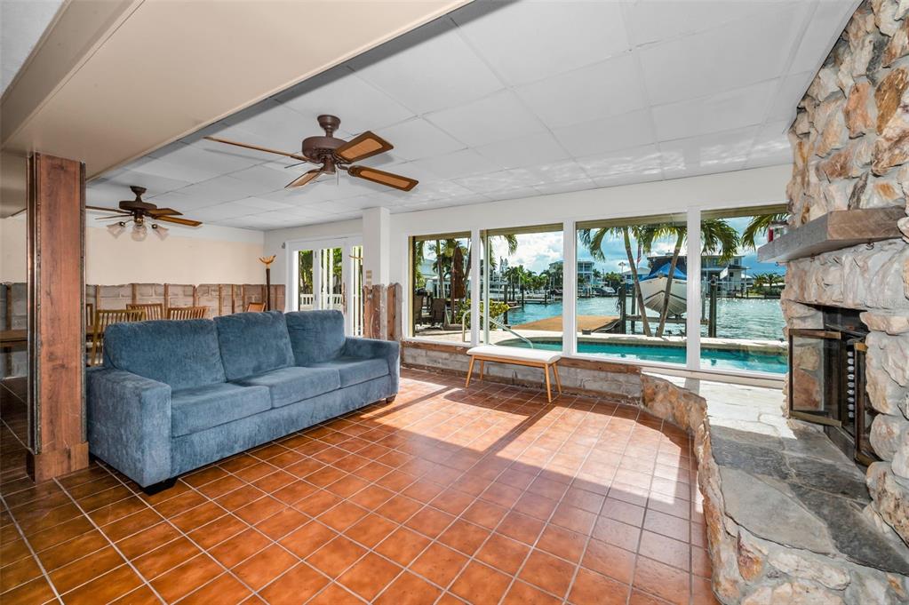 16108 6th Street East Redington Beach, FL 33708 - Photo 17 of 60 a living room with furniture and a floor to ceiling window