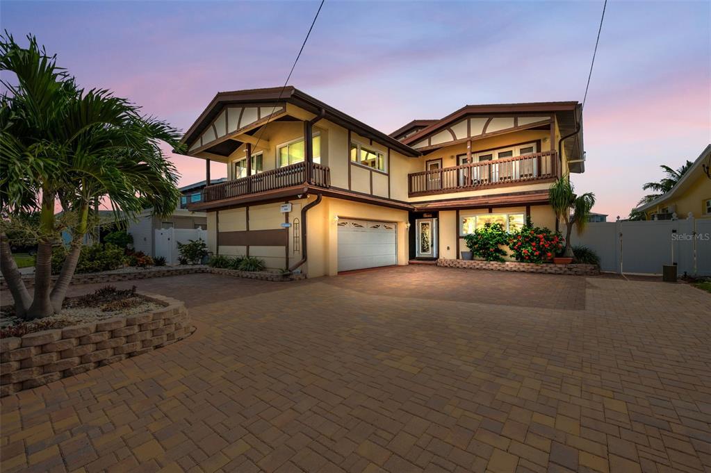 16108 6th Street East Redington Beach, FL 33708 - Photo 2 of 60 a front view of a house with a garden