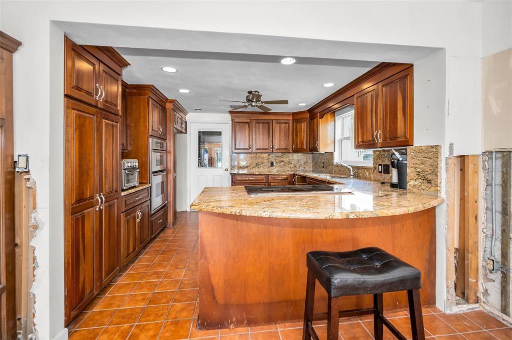 16108 6th Street East Redington Beach, FL 33708 - Photo 23 of 60 a kitchen with stainless steel appliances granite countertop a refrigerator and a stove top oven