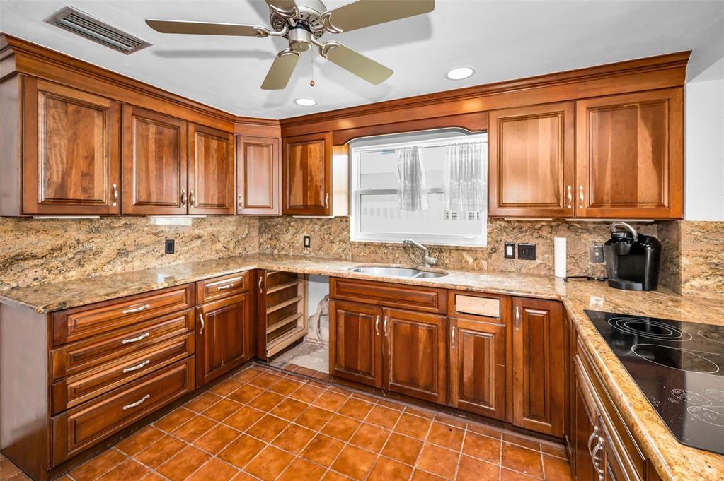 16108 6th Street East Redington Beach, FL 33708 - Photo 24 of 60 a kitchen with stainless steel appliances granite countertop a sink and cabinets