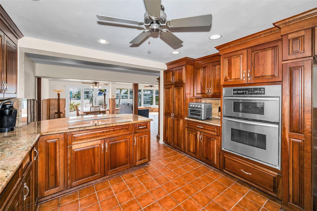 16108 6th Street East Redington Beach, FL 33708 - Photo 26 of 60 a kitchen with stainless steel appliances granite countertop a stove and a refrigerator
