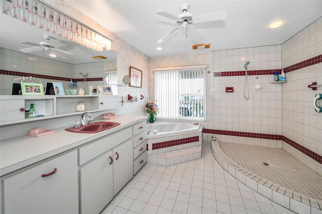 16108 6th Street East Redington Beach, FL 33708 - Photo 32 of 60 a bathroom with a tub sink and mirror
