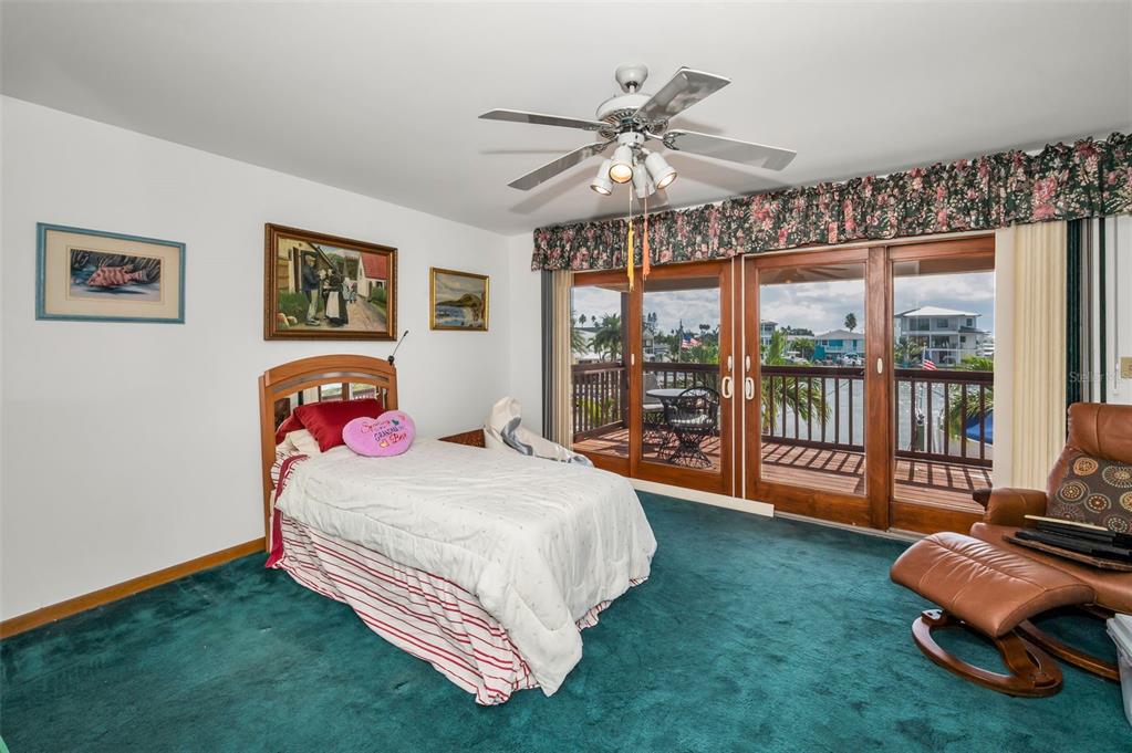 16108 6th Street East Redington Beach, FL 33708 - Photo 37 of 60 a bedroom with a bed and glass door