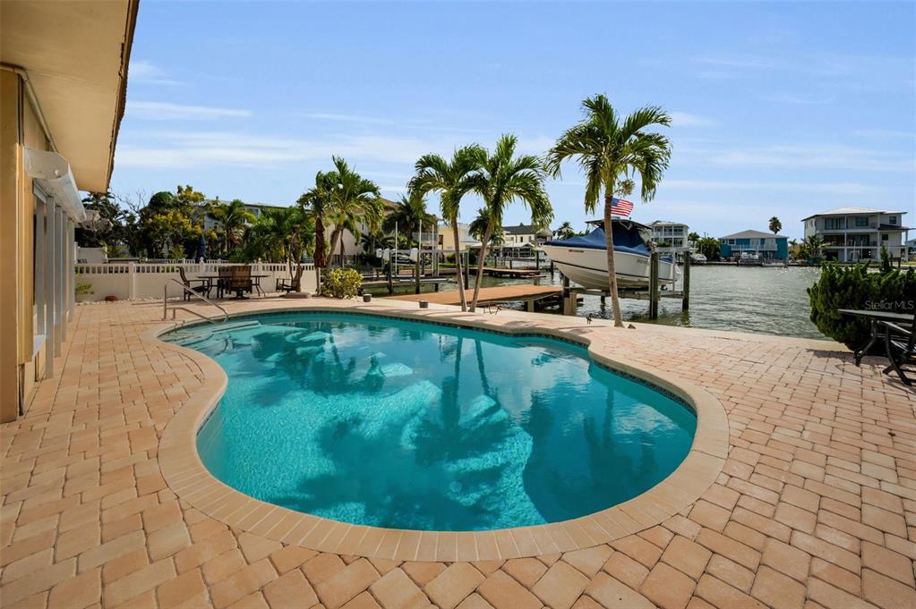 16108 6th Street East Redington Beach, FL 33708 - Photo 44 of 60 a view of a swimming pool with outdoor seating