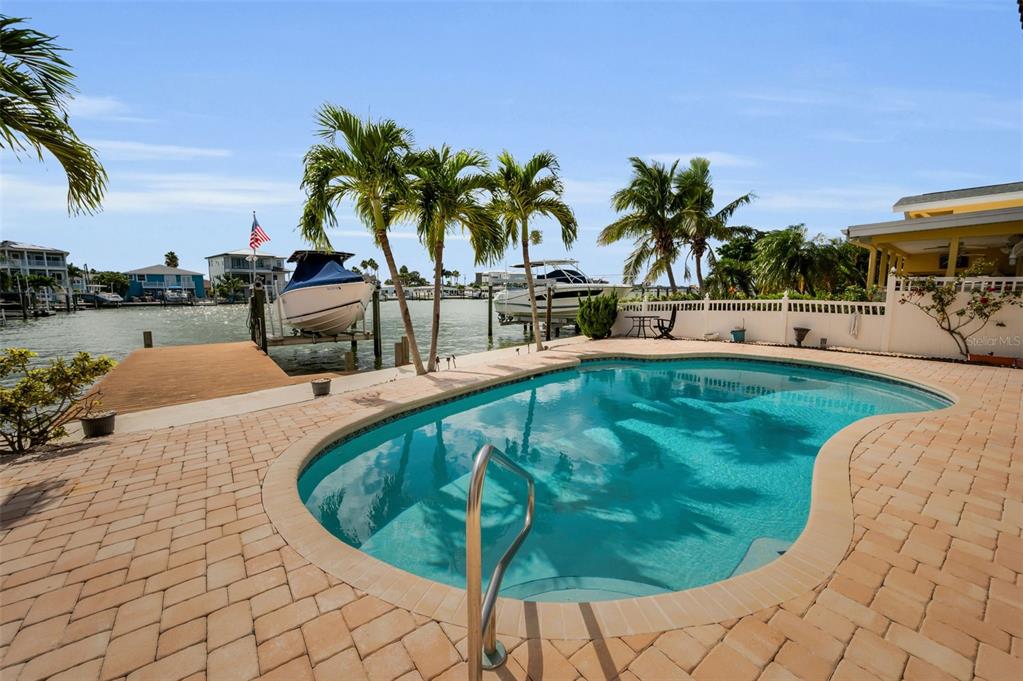 16108 6th Street East Redington Beach, FL 33708 - Photo 45 of 60 a view of a swimming pool with a lounge chair