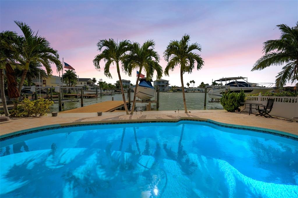 16108 6th Street East Redington Beach, FL 33708 - Photo 6 of 60 a view of a swimming pool with a table and chairs