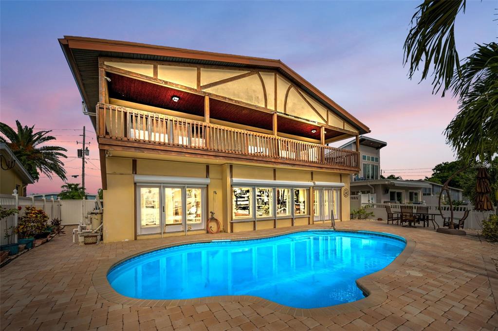 16108 6th Street East Redington Beach, FL 33708 - Photo 9 of 60 a view of swimming pool with outdoor seating and house in the background
