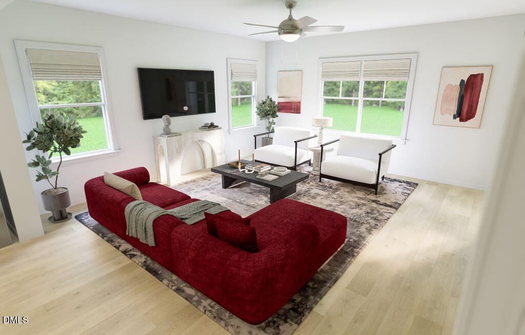 713 Bolera Road Knightdale, NC 27545 - Photo 11 of 35 a living room with furniture a flat screen tv and a large window