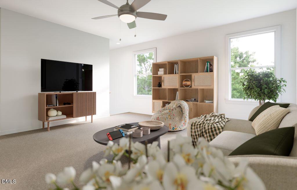 713 Bolera Road Knightdale, NC 27545 - Photo 14 of 35 a living room with furniture and a flat screen tv