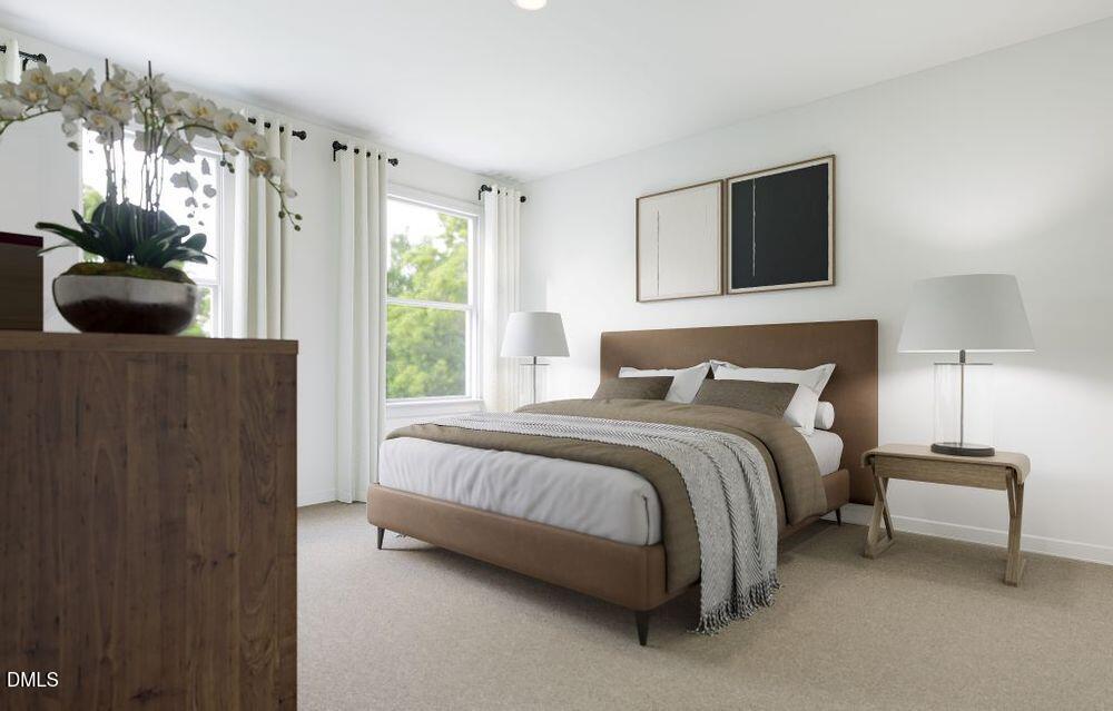 713 Bolera Road Knightdale, NC 27545 - Photo 20 of 35 a bedroom with a bed and a couch