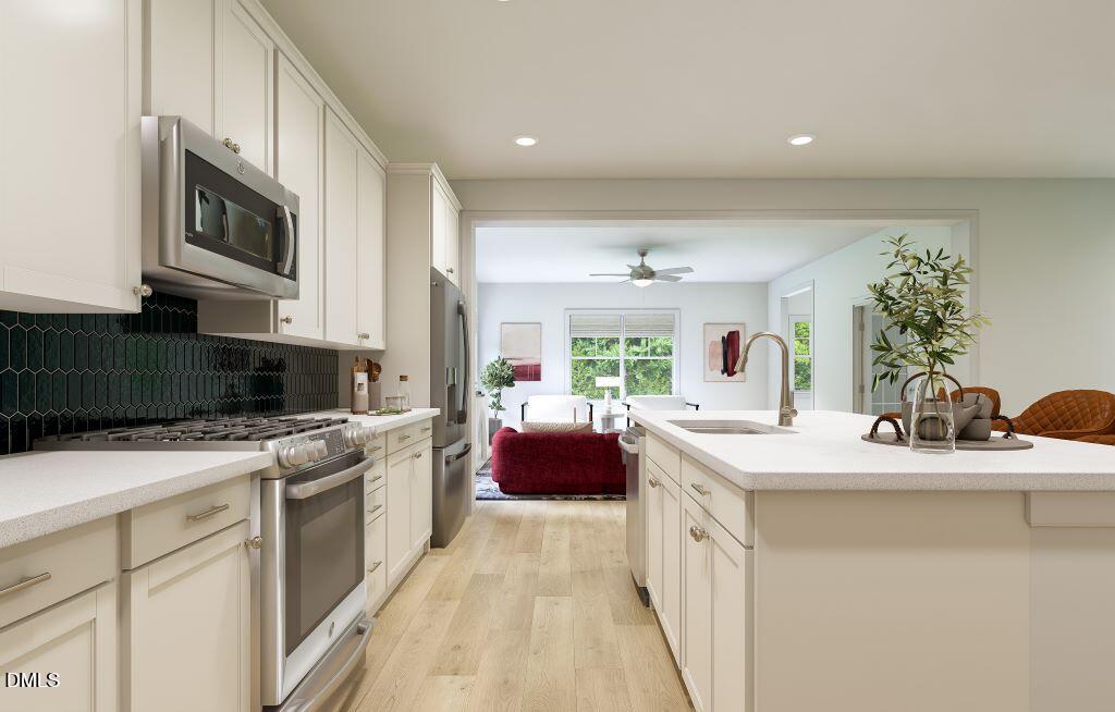 713 Bolera Road Knightdale, NC 27545 - Photo 9 of 35 a kitchen with stainless steel appliances granite countertop a sink stove and microwave