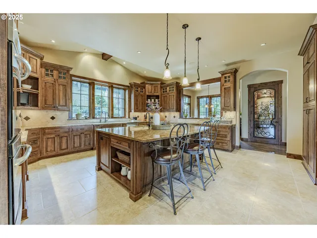 a view of a dining room with furniture and a chandelier