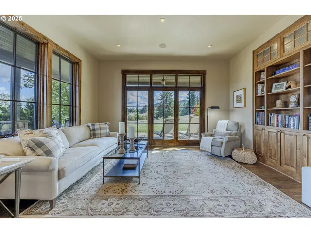 a living room with furniture and a large window with outer view