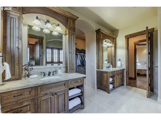 a spacious bathroom with a sink and a large mirror