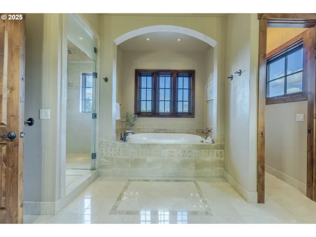 a bathroom with a tub shower and sink