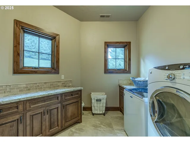 a view of a bathroom with washing machine and sink
