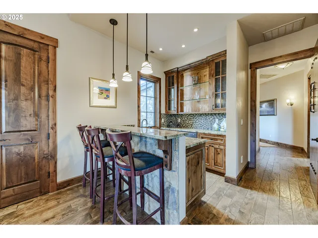 a open kitchen with granite countertop a sink cabinets and wooden floor