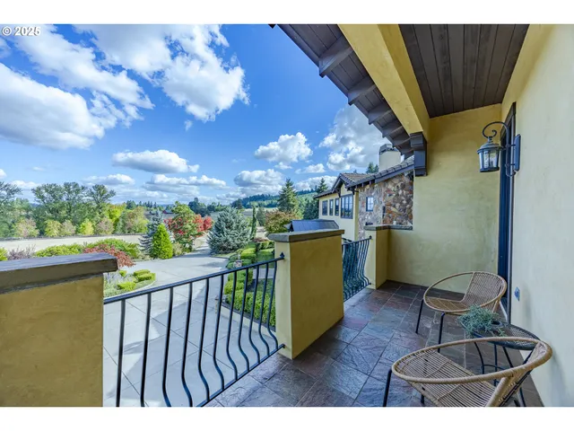 a view of a chairs and table in the balcony