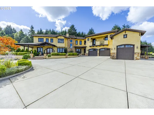 a picture of a building with a yard and a garage