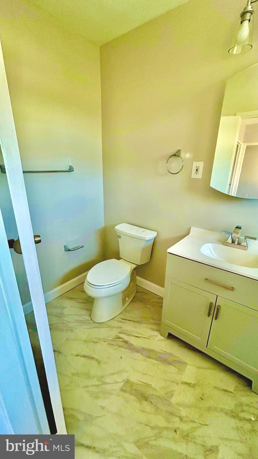 5319 Pooks Hill Road, Unit 1 Bethesda, MD 20814 - Photo 29 of 37 a bathroom with a sink a toilet and a mirror