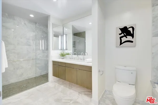 a view of bathroom with a toilet sink and mirror