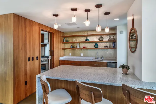 a kitchen with stainless steel appliances granite countertop a sink a stove and a refrigerator
