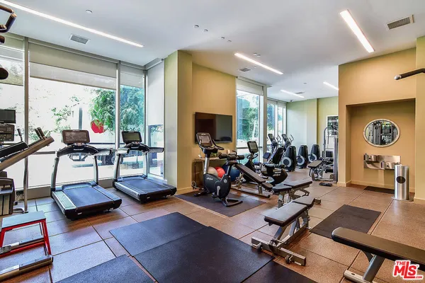 a room with gym equipment and a large window