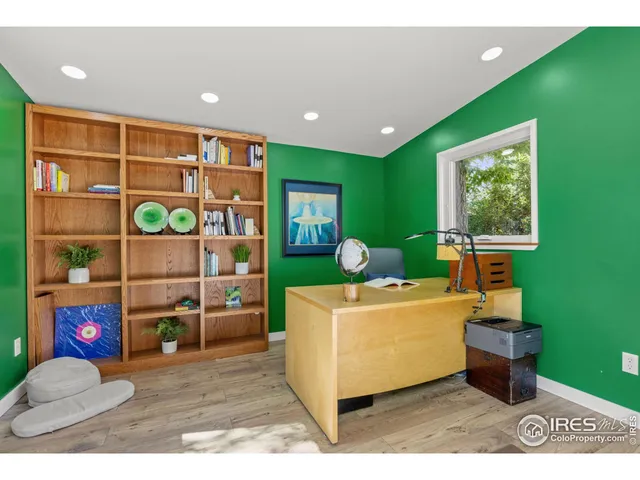 a living room with a couch and bookshelf