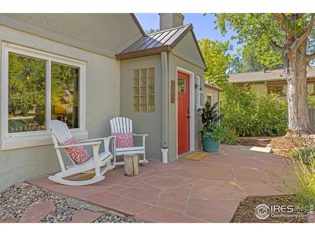 a view of a patio with a table chairs and a backyard