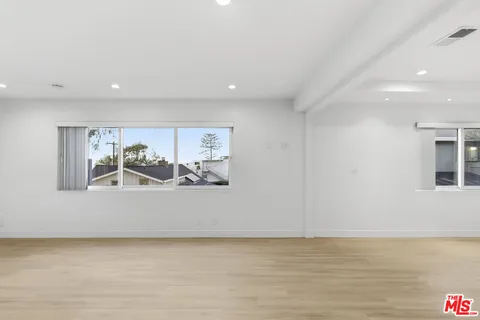 a view of a room with rack on the wall and a large window
