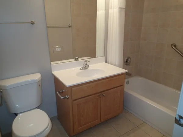 a bathroom with a sink toilet vanity and bathtub
