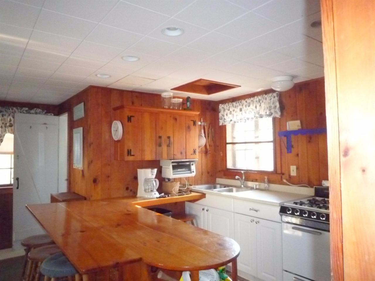 86 Depot Road Cataumet, MA 02534 - Photo 3 of 13 a kitchen with a table chairs sink and cabinets