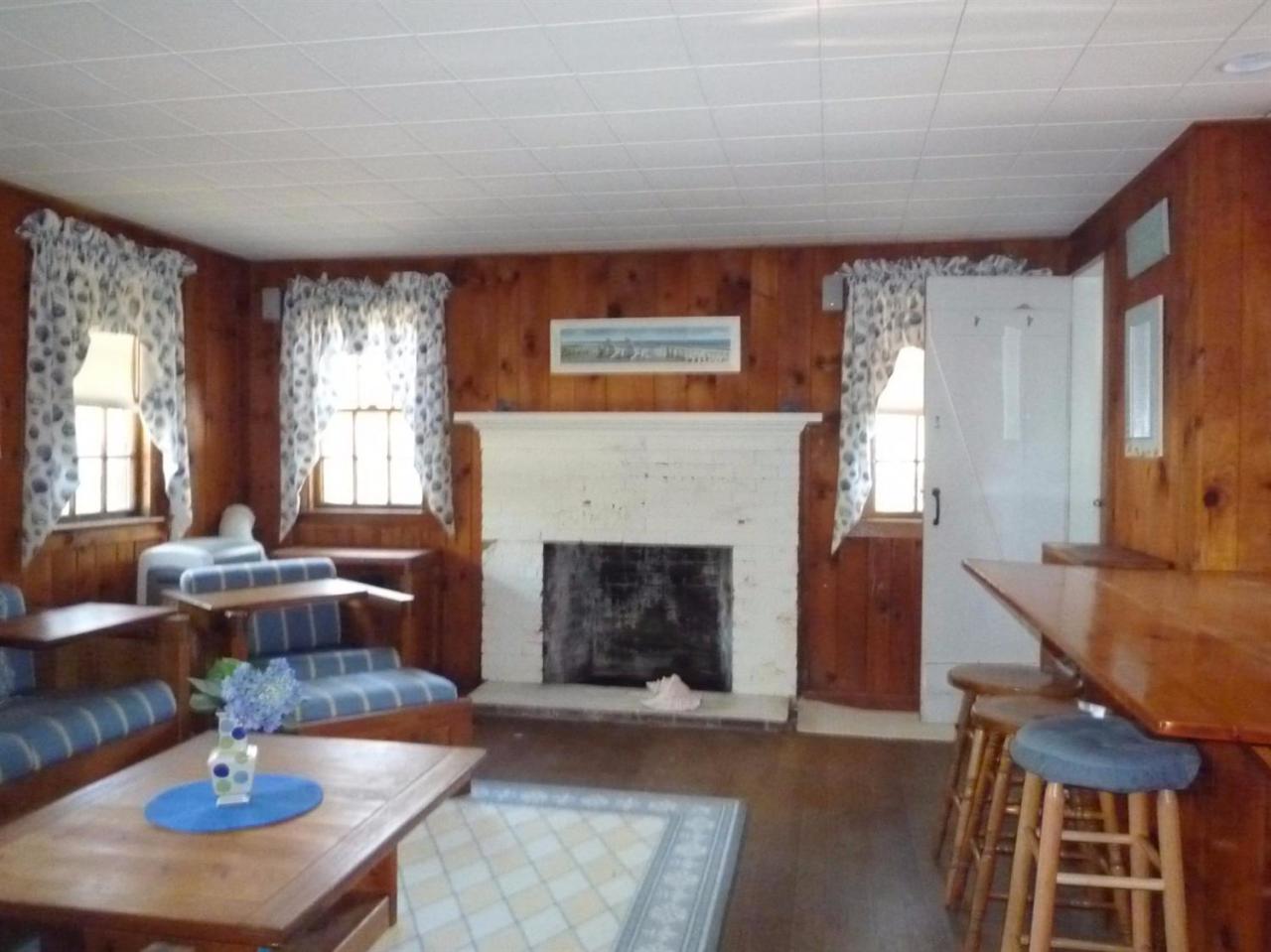 86 Depot Road Cataumet, MA 02534 - Photo 4 of 13 a living room with furniture a fireplace and a large window