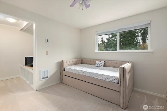 a bathroom with a granite countertop sink and a toilet