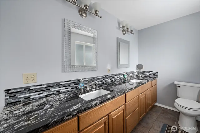 a bed room with a bed and a ceiling fan