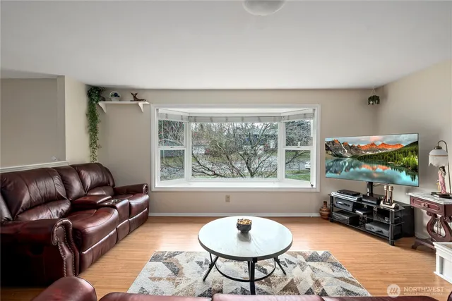 a living room with furniture a window and a table