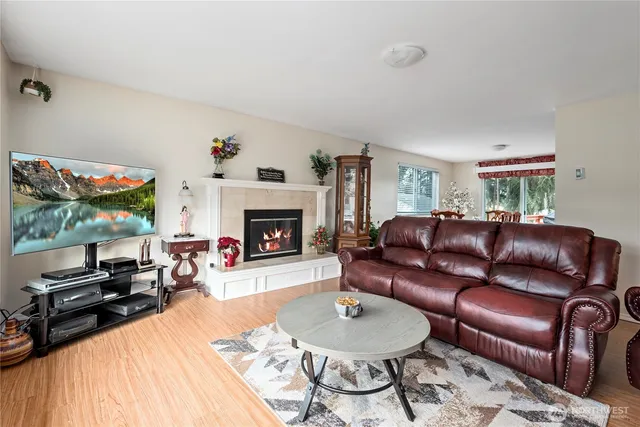 a living room with furniture fireplace and a large window