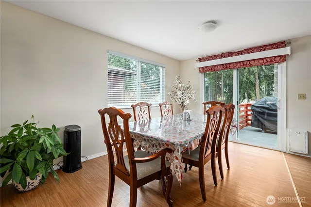 a dining room with furniture and wooden floor