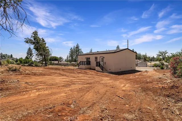 a view of a barn in the middle of a yard