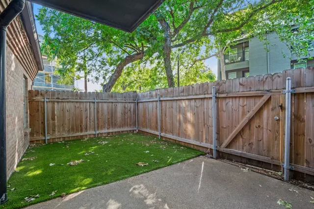 a view of a backyard with wooden fence
