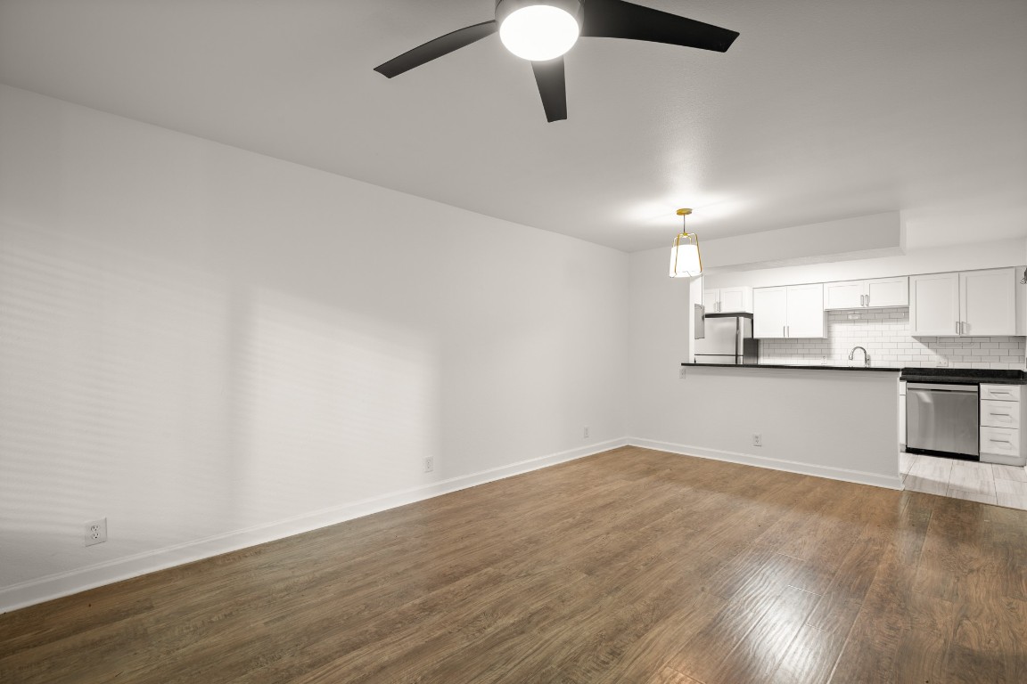 2020 South Congress Avenue, Unit 2102 Austin, TX 78704 - Photo 7 of 22 an empty room with wooden floor cabinet and windows