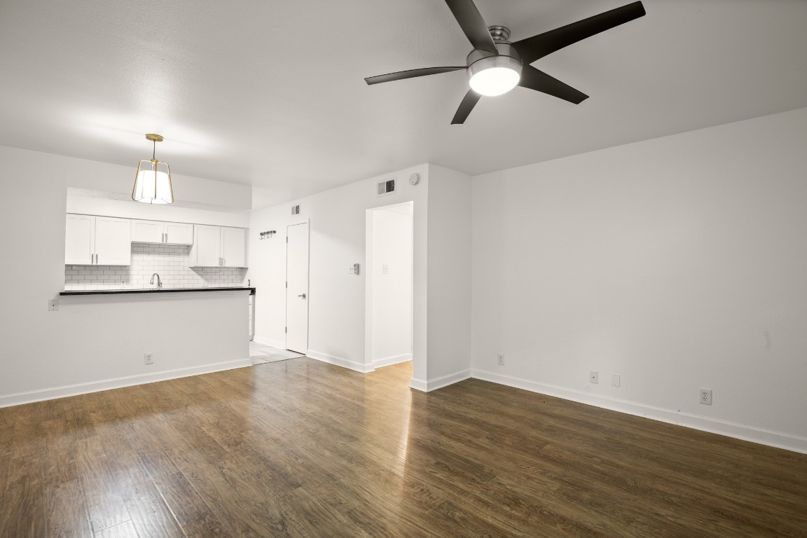 2020 South Congress Avenue, Unit 2102 Austin, TX 78704 - Photo 9 of 22 a view of a kitchen with wooden floor a sink a refrigerator and window