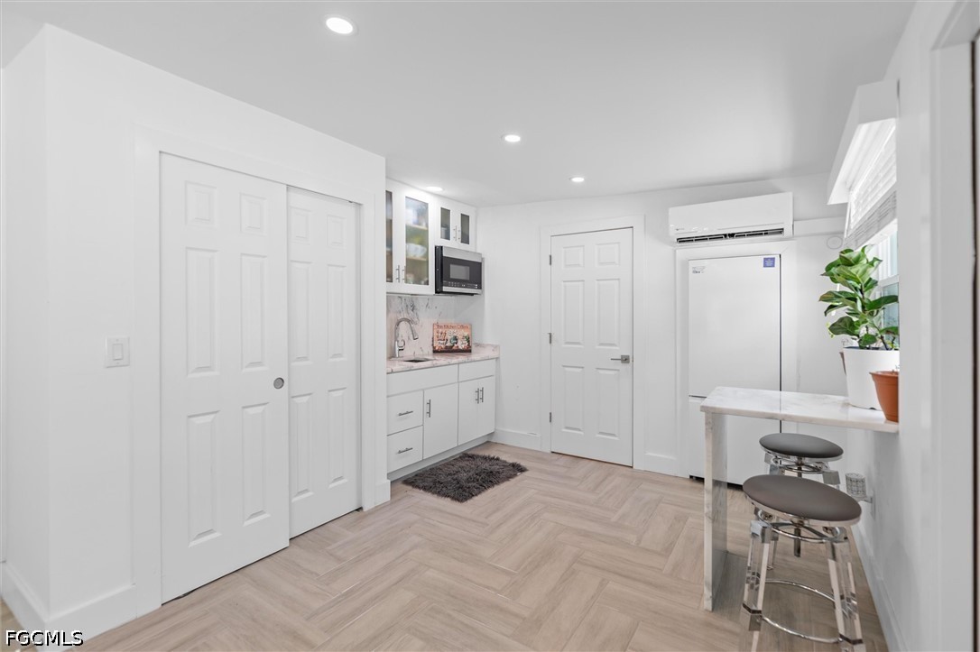 1200 Patterson Road Cape Coral, FL 33909 - Photo 27 of 42 a room with a chair and white walls