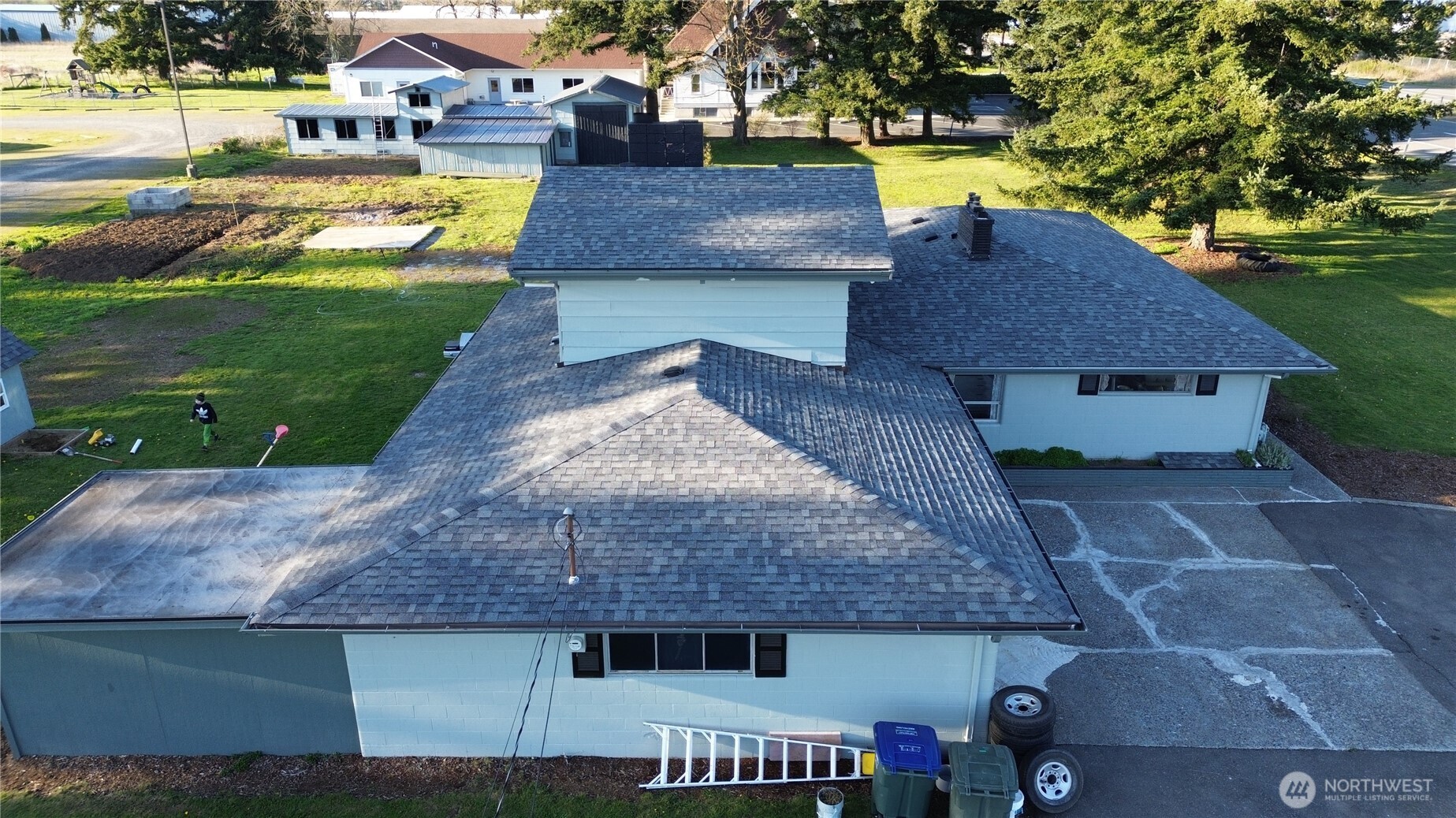 an aerial view of a house with a yard patio and swimming pool