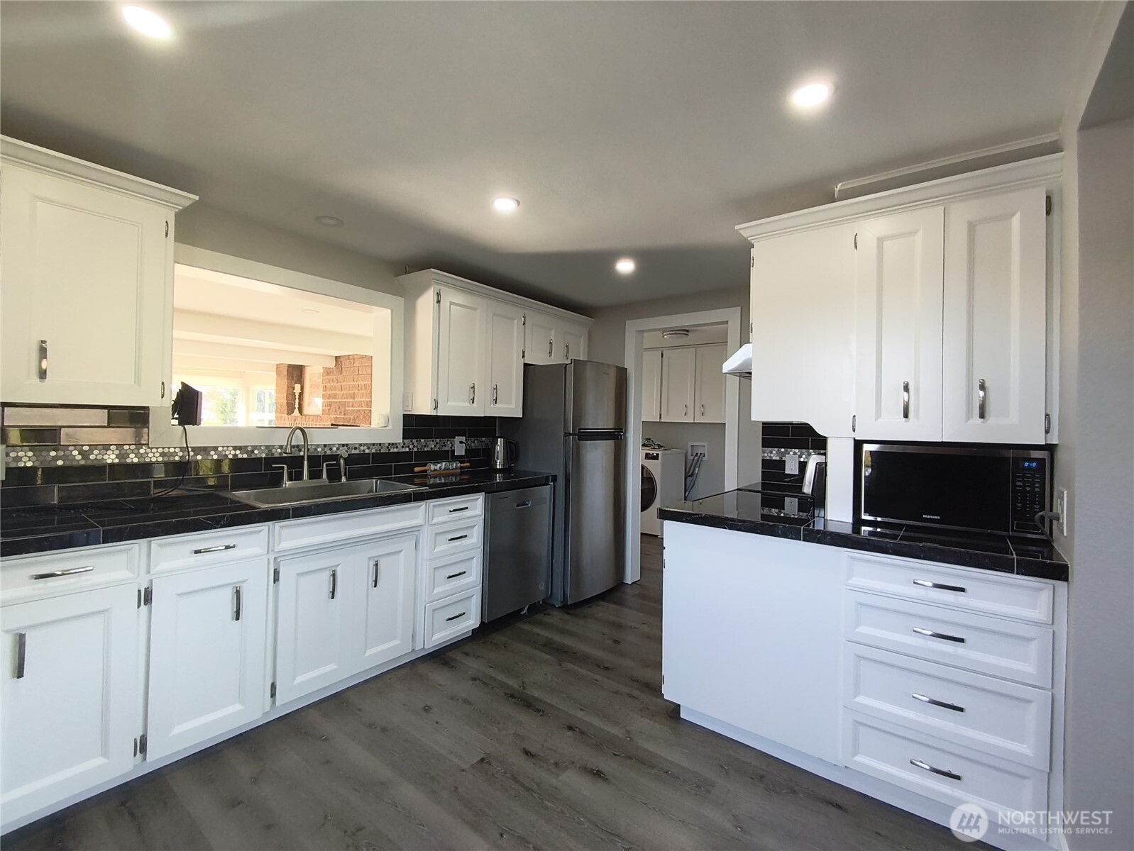 108 West Bartlett Road Lynden, WA 98264 - Photo 12 of 24 a kitchen with granite countertop white cabinets and stainless steel appliances