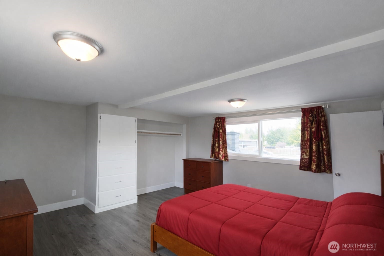 108 West Bartlett Road Lynden, WA 98264 - Photo 17 of 24 a bedroom with a bed and wooden floor