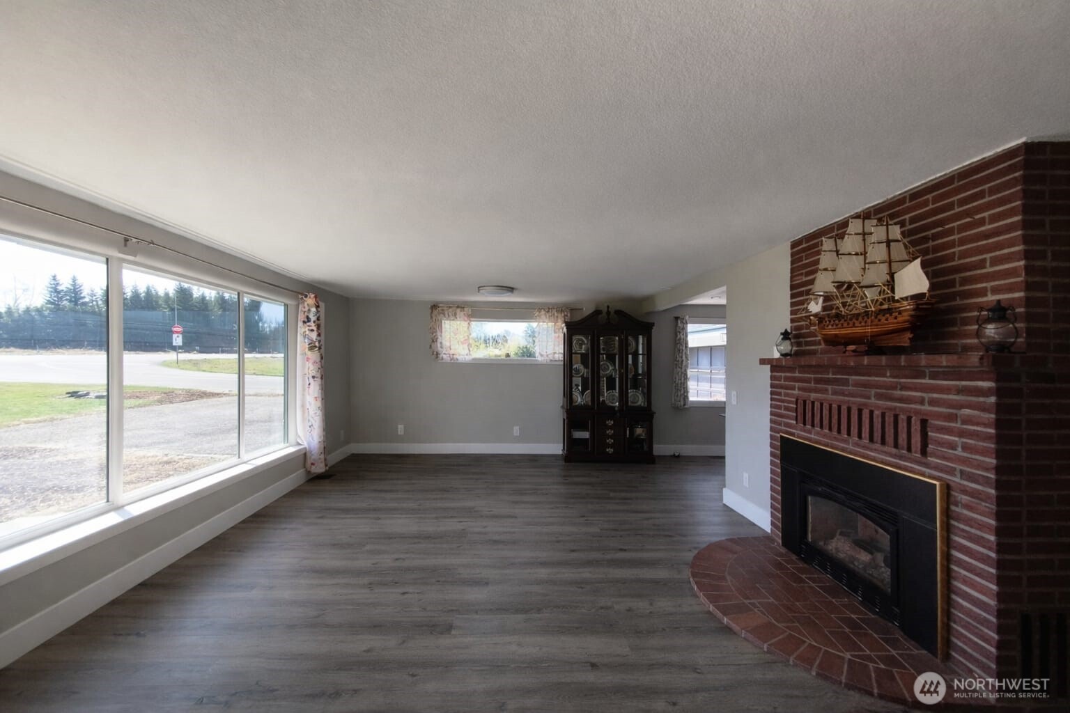 108 West Bartlett Road Lynden, WA 98264 - Photo 3 of 24 a view of empty room with wooden floor and fireplace