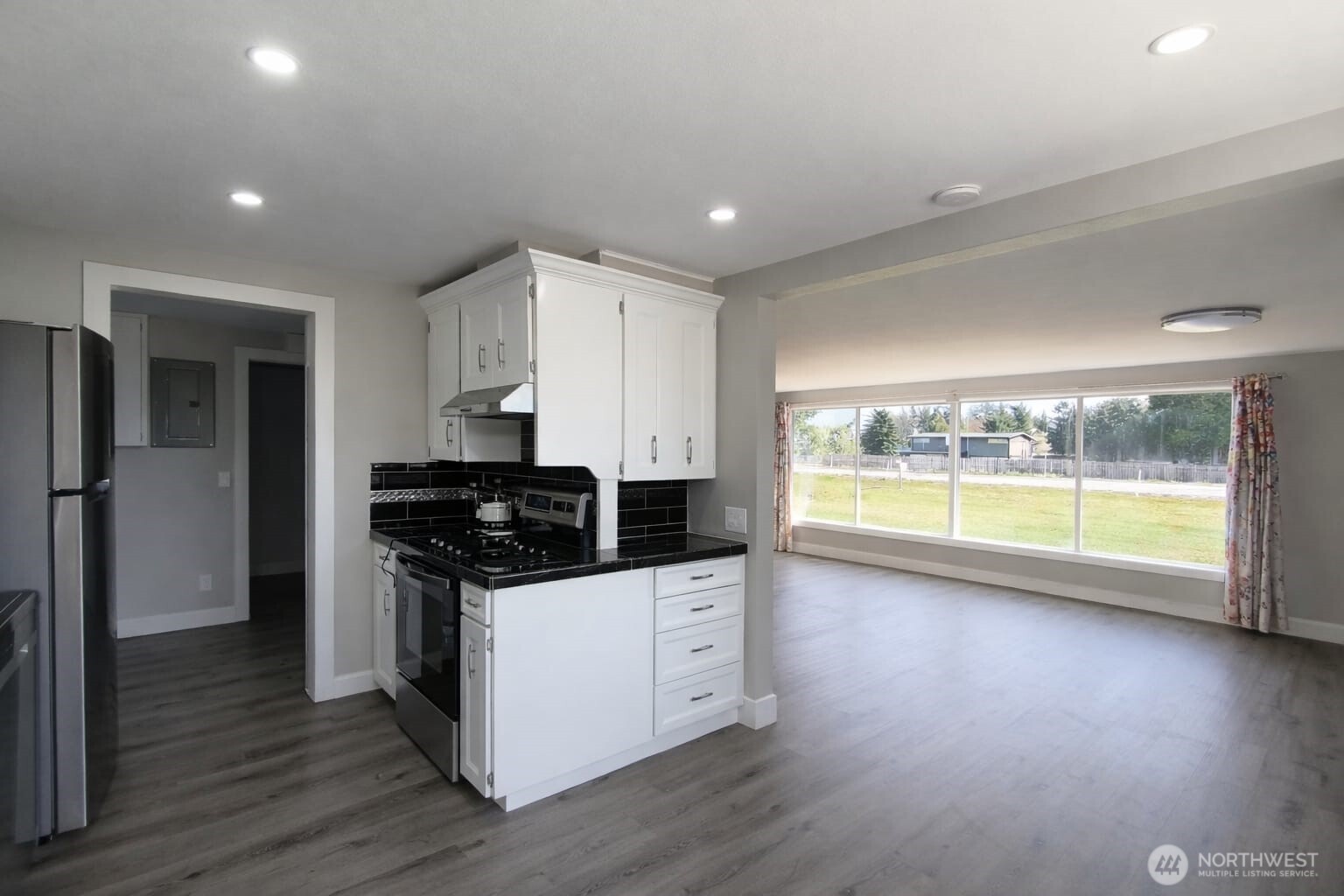 108 West Bartlett Road Lynden, WA 98264 - Photo 5 of 24 a kitchen with granite countertop a stove and a large window